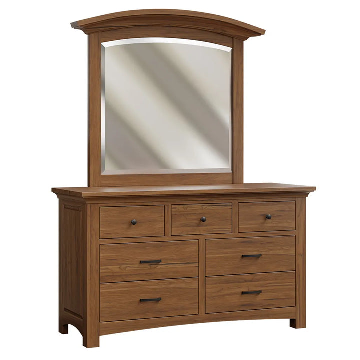 A wooden dresser with an attached arched mirror, featuring six drawers, dark metal handles, and a warm medium-brown finish on a white background.