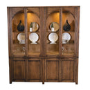 Wooden display cabinet with glass doors containing decorative items on a white background