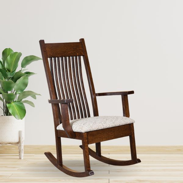 A handcrafted wooden rocking chair with a upholstered seat, shown in a social stain.