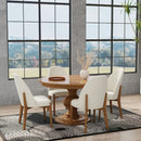 Dining room with wooden table and white chairs in front of large windows with a scenic view.