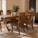 Wooden dining table with chairs in a well-lit room