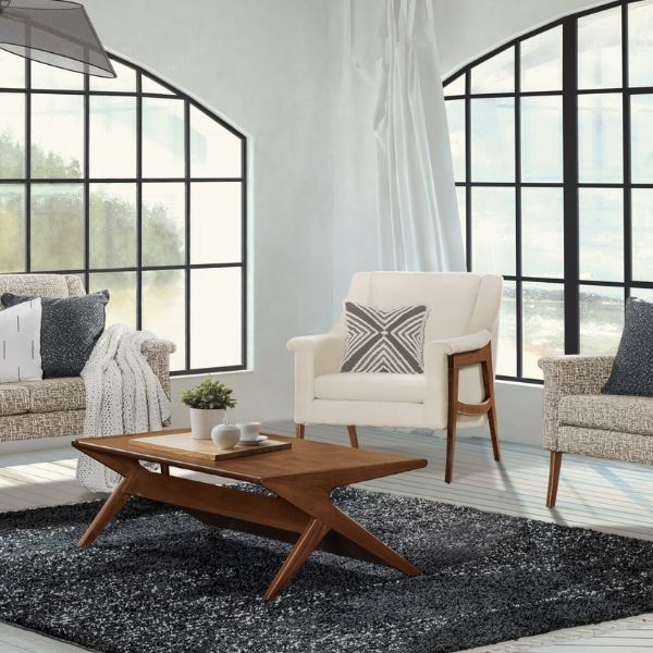 dining table that is brown with a white chair and 2 grey chairs by it under a blue rug