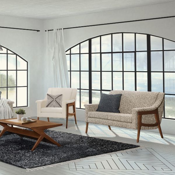 living room with grey carpet and 2 wooden furniture pieces
