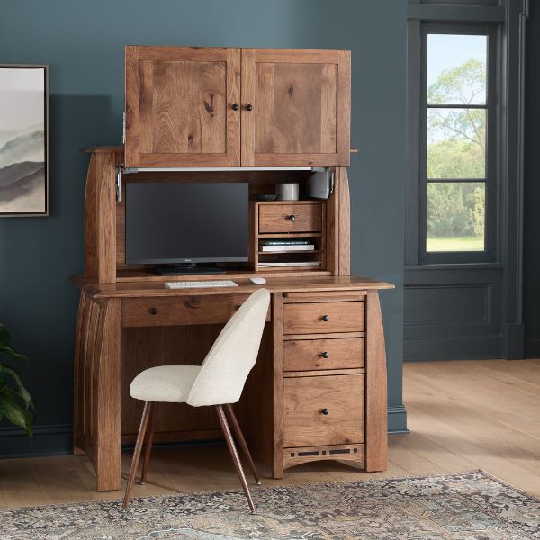 wooden desk that opens to reveal a computer and a white chair next to it