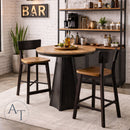 Dining area with round wooden table and black chairs in a kitchen setting.