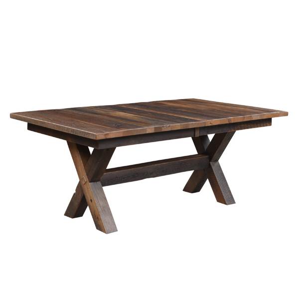 A rustic style brown barnwood trestle extension table with a solid top and hand-worn corners, designed for dining spaces.