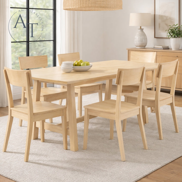 Dining room with wooden table and chairs in a well-lit room.