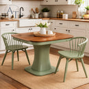 Dining table with wooden top and green base in a kitchen setting