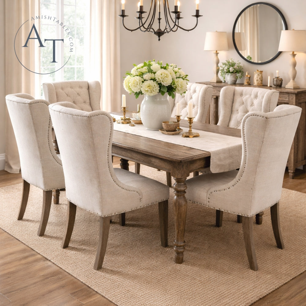 Dining room with wooden table and upholstered chairs, featuring a chandelier and decorative elements.