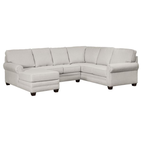 A 'Ellington' sectional sofa with a white upholstery, having a solid hardwood maple frame, in a living room setting.