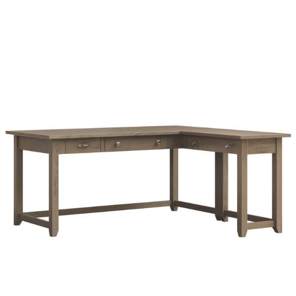 A brown maple wood corner desk with a sandstone stain finish, featuring a keyboard pull-out on the return, pencil drawer, and standard drawer.