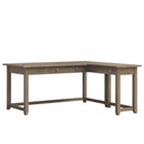 A brown maple wood corner desk with a sandstone stain finish, featuring a keyboard pull-out on the return, pencil drawer, and standard drawer.