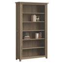 A brown wooden Premier bookcase with adjustable shelves, featuring a Shaker style design.