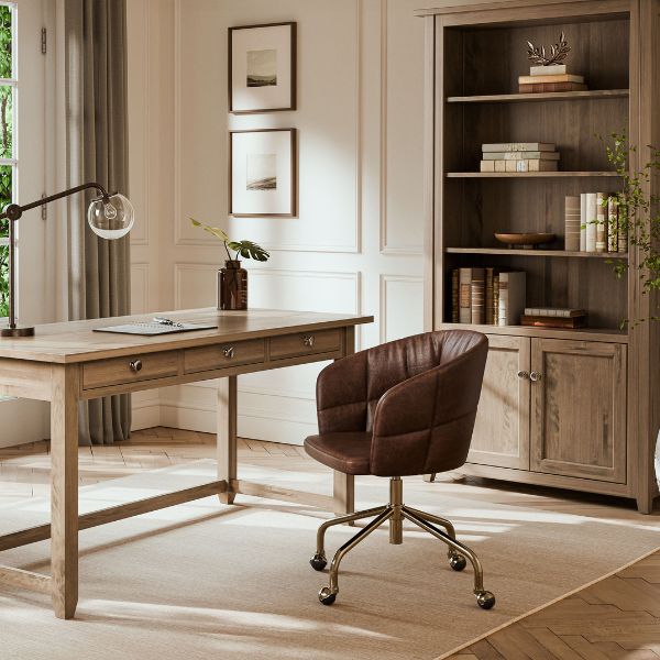 light wooden desk with a brown leather chair