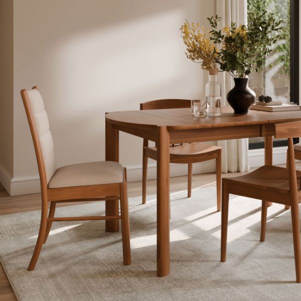 dining room table with matching chairs an a vase on top of the table.
