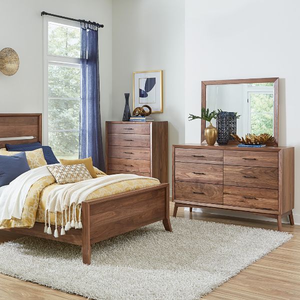 a bedroom with dark wood furniture