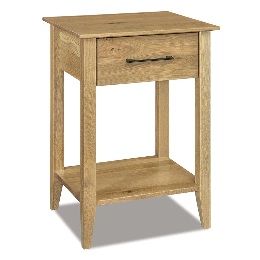 A light oak wood nightstand with a single drawer featuring a black metal pull handle and an open lower shelf, shown on a white background with a soft shadow.