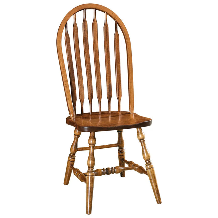 A classic wooden spindle-back dining chair with a warm medium brown finish, shown against a plain white background.