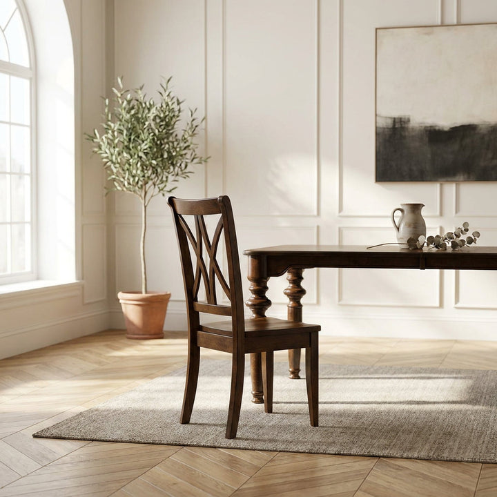 A dark brown wooden dining chair positioned next to a matching wooden table in a bright, modern dining room with a light-colored rug, a potted olive tree, and wall paneling.