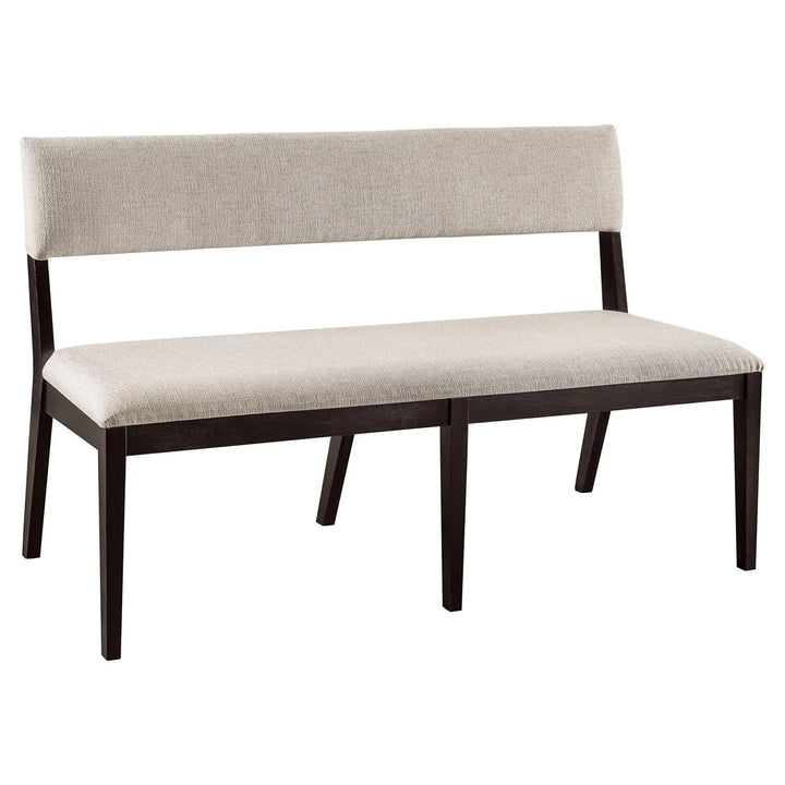 A modern dining bench with a light beige textured fabric seat and backrest, supported by a dark brown wooden frame with angled legs, shown on a plain white background.