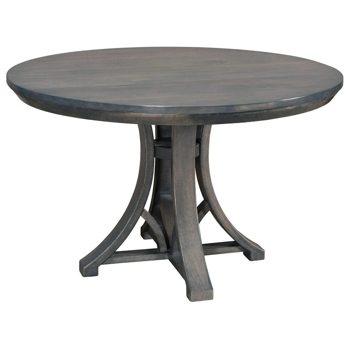A round dining table with a dark gray wood finish and a curved pedestal base, shown on a plain white background.