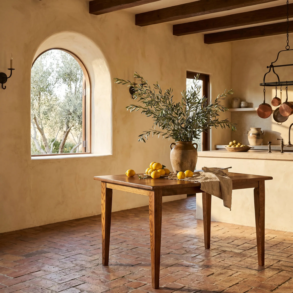 Dining area with wooden table, potted plant, and window view of greenery.