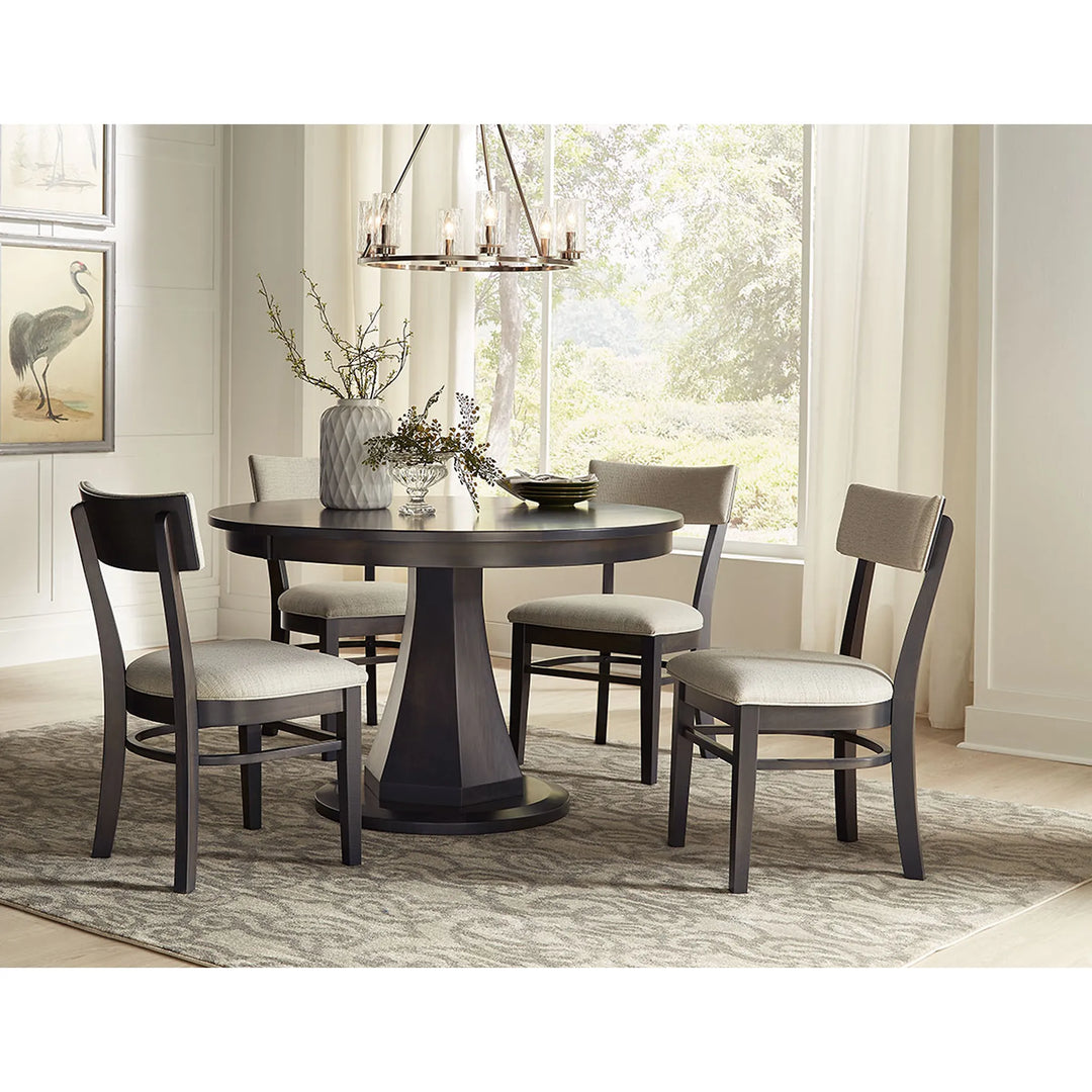 A 5-piece round dining table set with four dark wood chairs featuring light beige upholstered seats, shown in a bright, modern dining room setting.