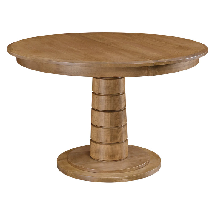 A round wooden dining table with a medium brown finish, featuring a tiered pedestal base and a circular tabletop, shown against a plain white background.