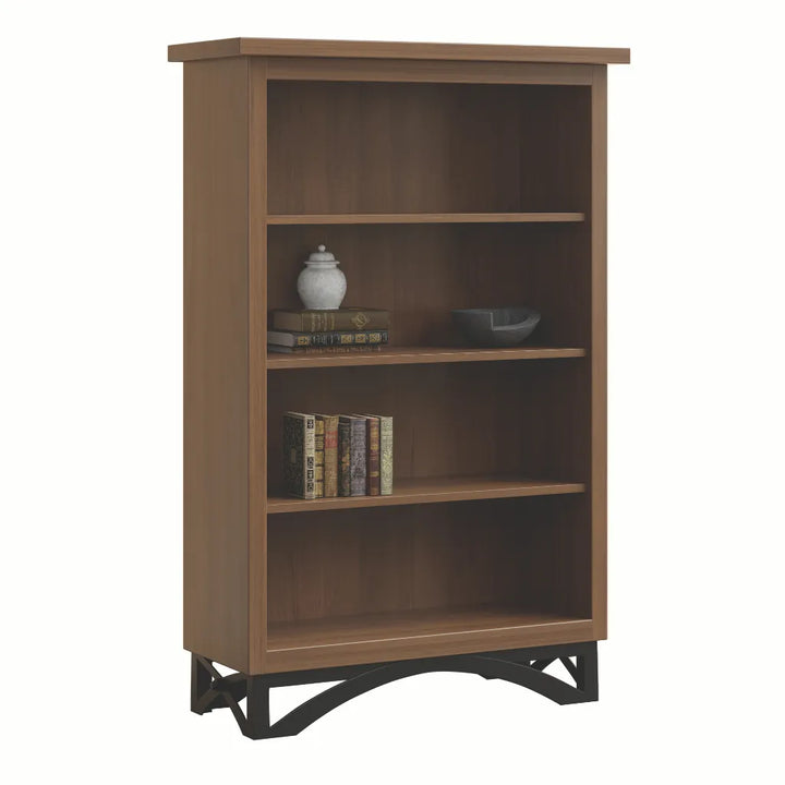A three-tier wooden bookcase with a medium brown finish and black metal support feet, shown on a plain white background with decorative books and vases on the shelves.