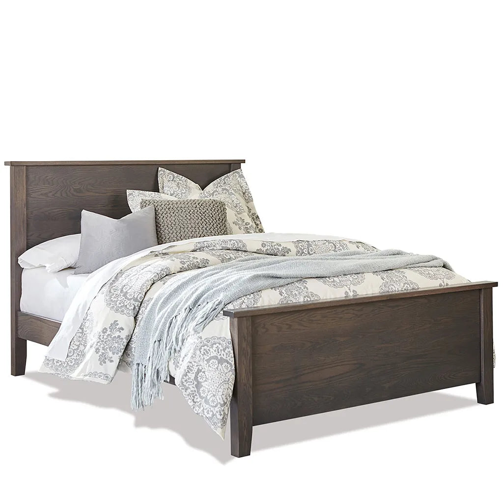 A dark brown wooden bed frame with a high headboard and footboard, styled with patterned beige and gray bedding, pillows, and a light blue throw blanket on a white background.