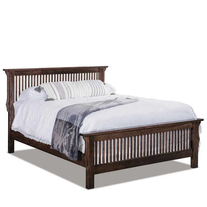 A dark brown wooden bed frame with a slatted headboard and footboard, shown with white bedding and a gray throw blanket on a white background.