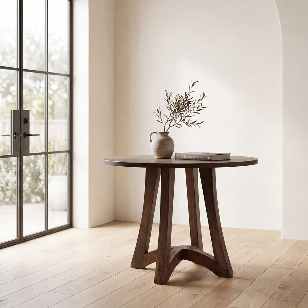 A walnut Tifton pub table in a modern light filled room with light oak floors and glass doors.