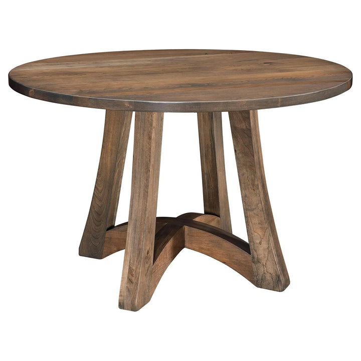 A round wooden dining table with a medium brown finish and a unique four-leg base that forms a cross at the bottom, shown on a plain white background.