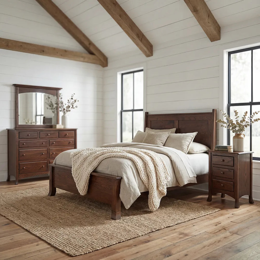 A rustic bedroom set featuring a dark brown wooden bed frame, matching nightstand, dresser with mirror, and a textured beige woven rug on a wood floor.