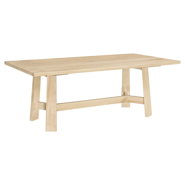 A light natural wood dining table with a rectangular top, four angled legs, and a horizontal stretcher bar, shown on a plain white background.