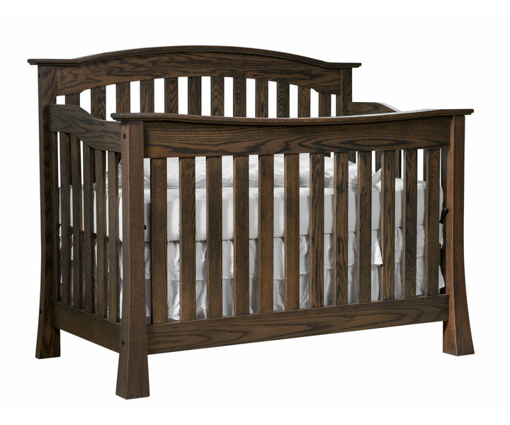 A dark knight brown wooden crib with a white mattress, constructed from solid hardwood with mortise &amp; tenon joints and decorative bronze connector bolts.