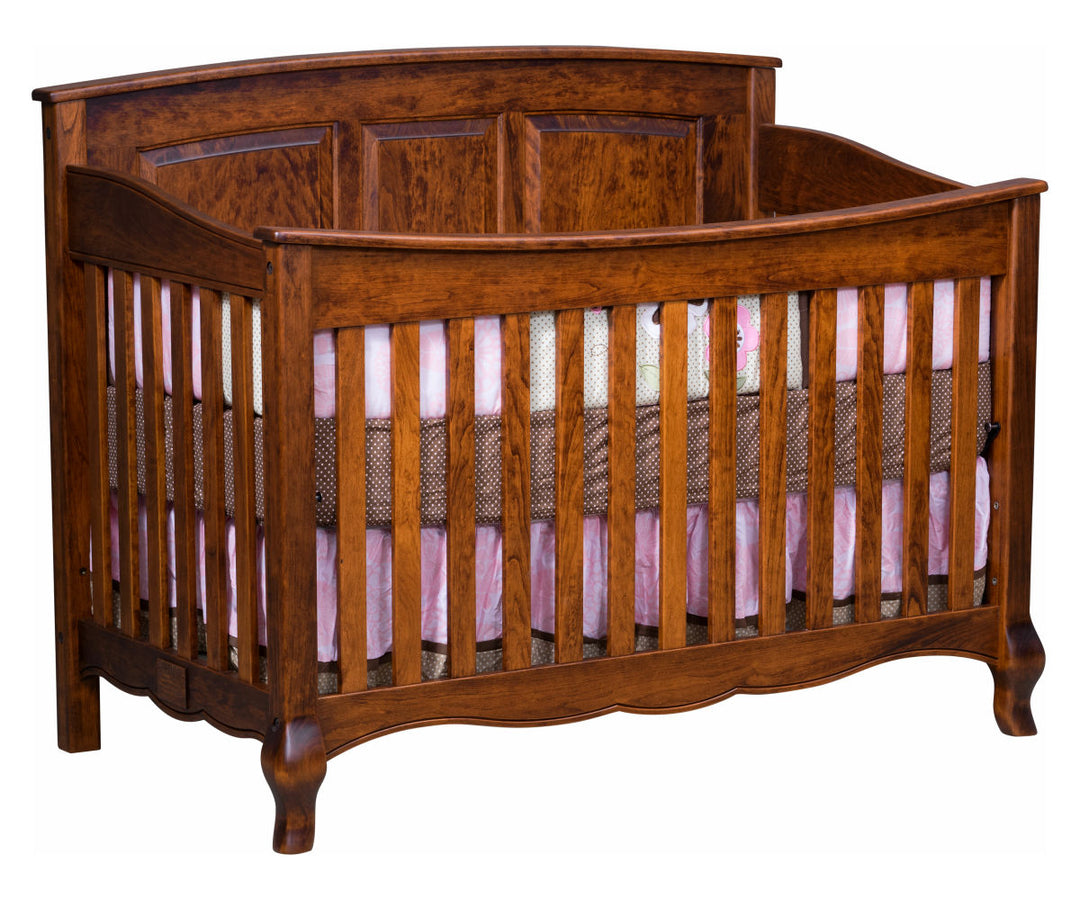 A French Country Crib made of solid hardwood with a rustic cherry wood finish. It features a set of conversion rails and is adorned with decorative bronze connector bolts.