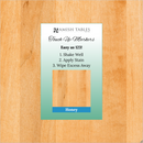 A product image featuring a 'Honey Touch Up Marker' packaging with a wooden background. The packaging is labeled with the brand 'Amish Tables' and has text instructions for use.